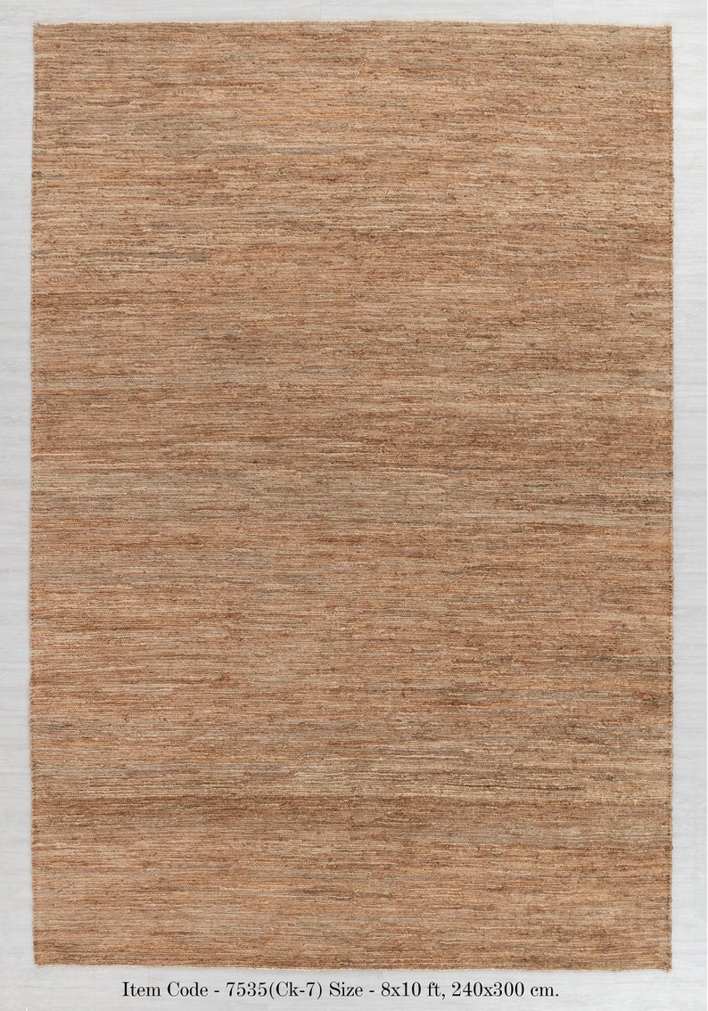 May include: A brown woven rug with a subtle striped pattern. The rug is 8 feet by 10 feet and measures 240 centimeters by 300 centimeters.