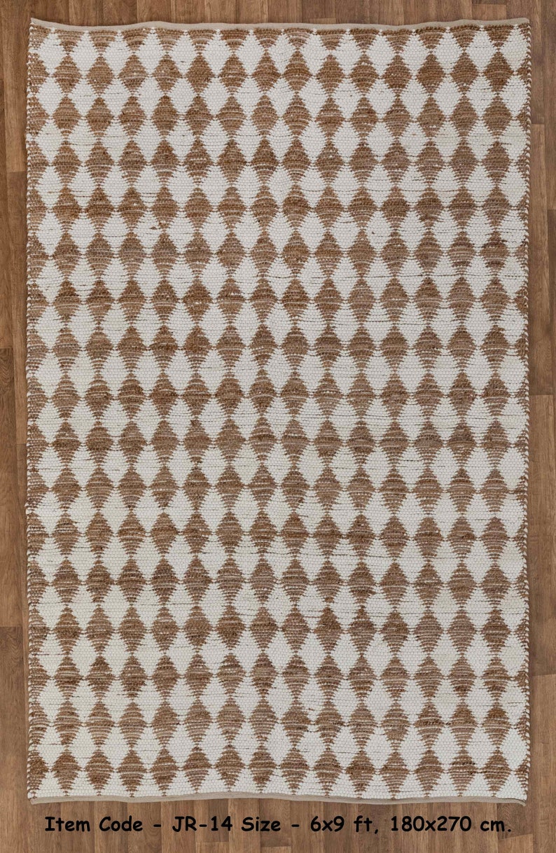 May include: A brown and white diamond patterned jute rug. Item Code - JR-14 Size - 6x9 ft, 180x270 cm.