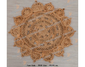 May include: A round, brown jute rug with a circular pattern of woven rope. The rug has a diameter of 90 cm.  Item Code - 5539 Size - 90x90 cm.