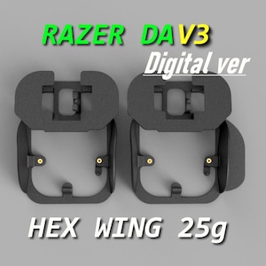 May include: Two black, geometric-shaped accessories with gold-colored accents. The text "RAZER DAV3 Digital ver" is above the accessories, and "HEX WING 25g" is below. The accessories have a unique, open design.