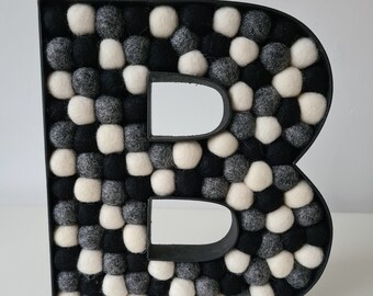 Monochrome Felt ball wooden letters, made up of light grey, white & black - Tracked UK delivery available