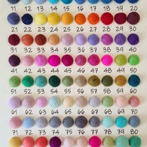 May include: A chart of 90 felt balls in various colours, numbered 1 to 90. The felt balls are arranged in 10 rows of 9 balls each. The chart is labelled "One Eight Three" at the bottom.