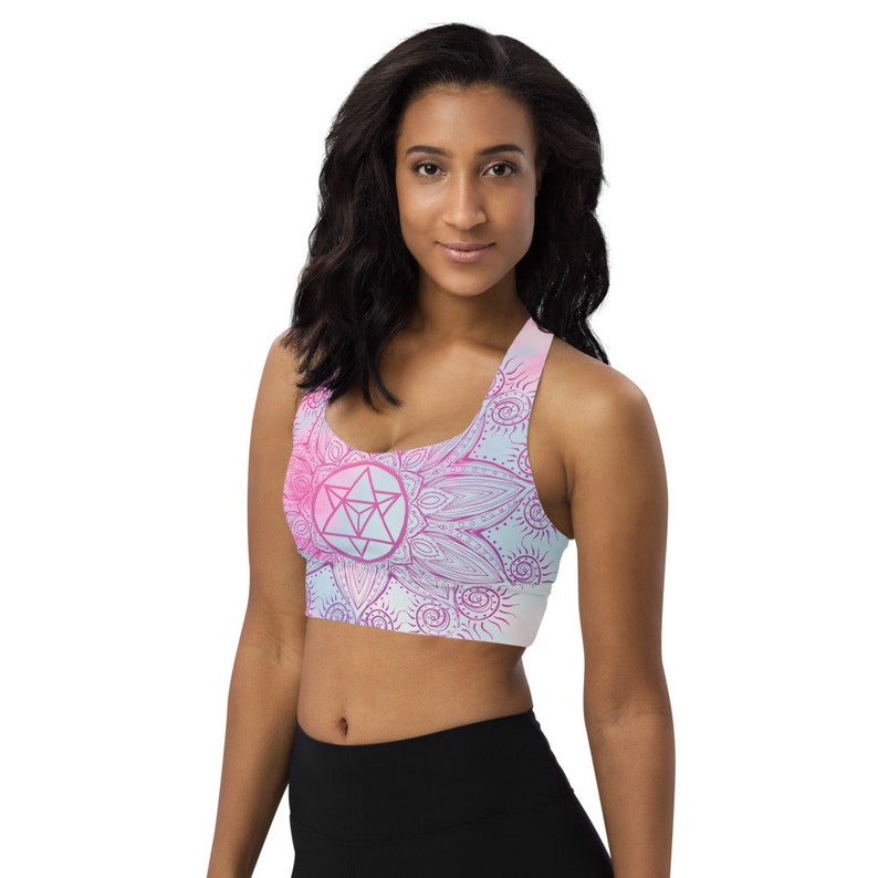 Goddess Swag Soul Star Chakra Mandala Racerback Sports Bra.  Background all over color is soft pastels of blues and pinks. the design on the front and back is the soul star with mandala in a deep pink.