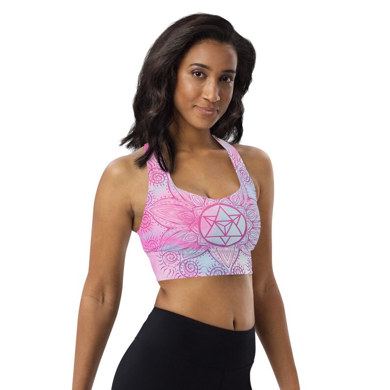 Goddess Swag Soul Star Chakra Mandala Racerback Sports Bra.  Background all over color is soft pastels of blues and pinks. the design on the front and back is the soul star with mandala in a deep pink.