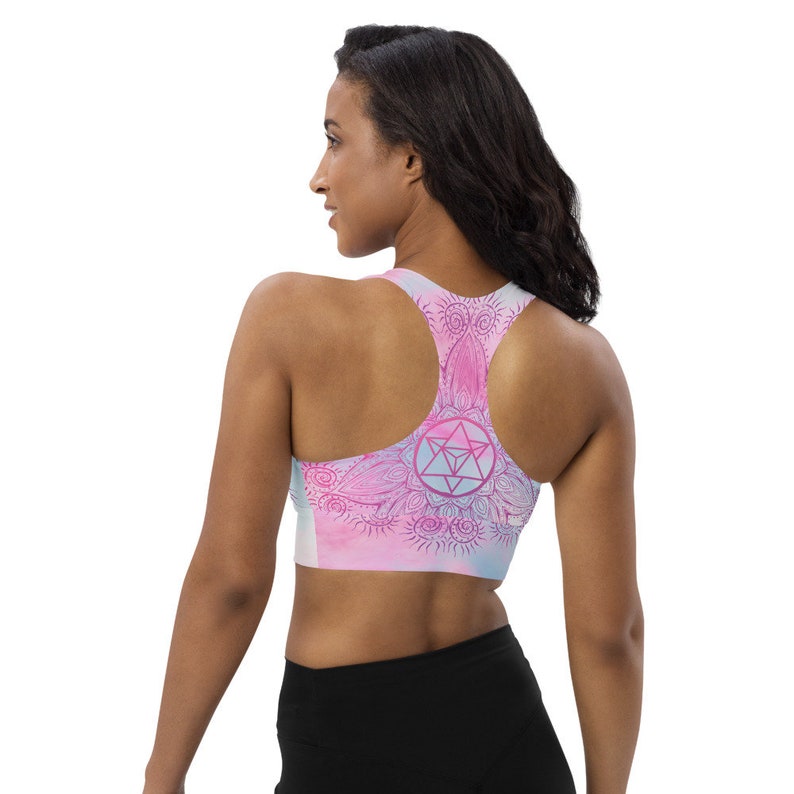 Goddess Swag Soul Star Chakra Mandala Racerback Sports Bra.  Background all over color is soft pastels of blues and pinks. the design on the front and back is the soul star with mandala in a deep pink.