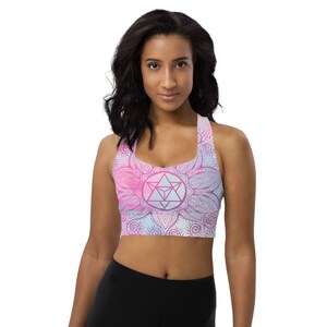 Goddess Swag Soul Star Chakra Mandala Racerback Sports Bra.  Background all over color is soft pastels of blues and pinks. the design on the front and back is the soul star with mandala in a deep pink.