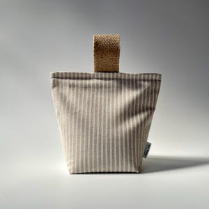 Taupe and white stripe fabric doorstop with jute handle.