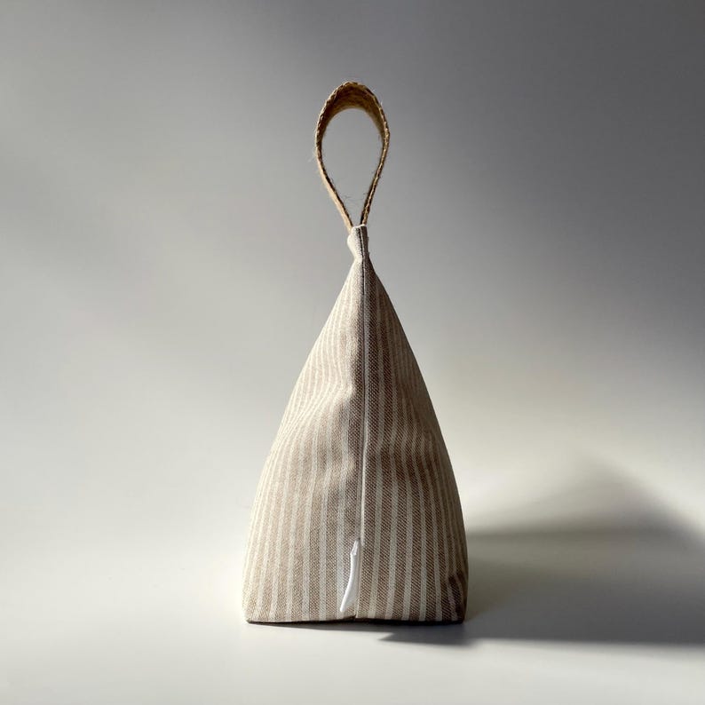 Taupe and white stripe fabric doorstop with jute handle.