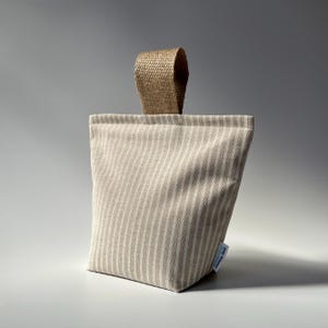 Taupe and white stripe fabric doorstop with jute handle.