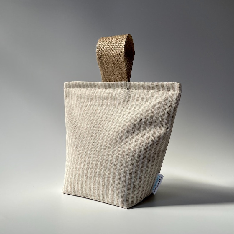 Taupe and white stripe fabric doorstop with jute handle.