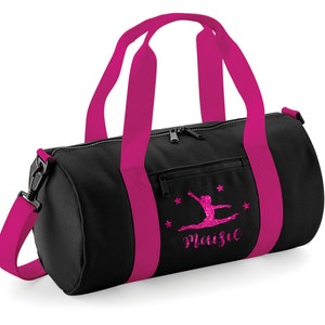 May include: Black gym bag with pink accents and a pink glitter design of a gymnast with the name Maisie.