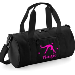 May include: Black gym bag with a pink silhouette of a gymnast doing a back handspring and the name "Maisie" printed on the front.