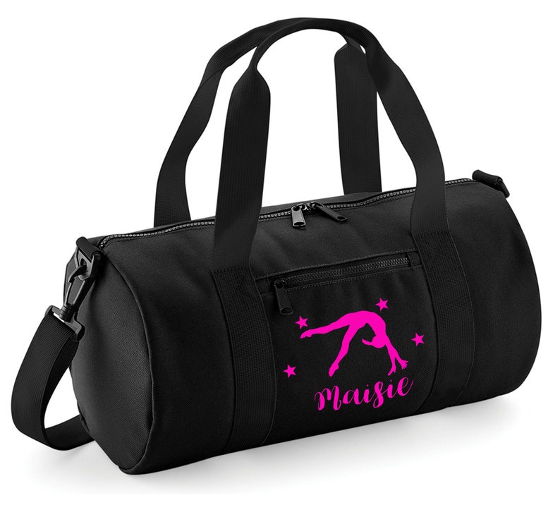 May include: Black gym bag with a pink silhouette of a gymnast doing a back handspring and the name "Maisie" printed on the front.