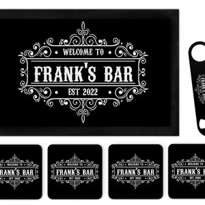 以下が含まれることがあります： 「ようこそFrank's Bar Est 2022へ」と白で書かれた黒いバーマット。セットには、同じデザインのコースター4枚と黒い栓抜き1個が含まれています。