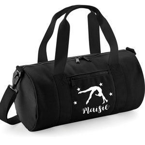 May include: Black gym bag with a white silhouette of a gymnast doing a back handspring and the name "Maisie" written below. There are five white stars around the gymnast.