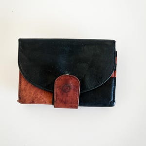 Vintage Black and Brown Wallet with Snap Closure