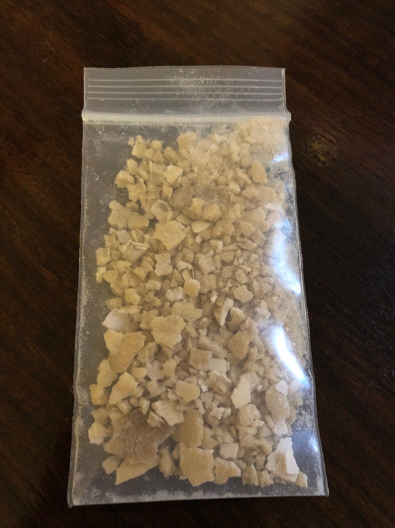 May include: A clear plastic bag filled with small, irregular pieces of light brown and white material.