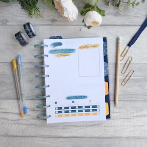 May include: A white planner page with a blue and yellow star pattern border. The page has sections for "Week of", "Spiritual Focus & Prayers", "Memory Verse", and "Habit Tracker".