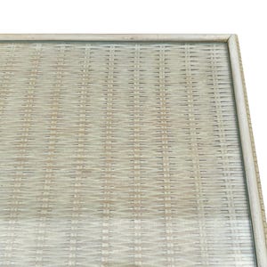 May include: Close-up of a rectangular, light-colored woven tray with a light-colored frame. The woven pattern is a tight, repeating design. The tray is likely made of natural materials.