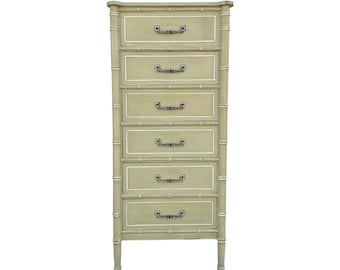 May include: A tall, sage green chest of drawers with six drawers. The chest has a bamboo-style frame with white trim and dark metal handles. The legs are short and tapered.