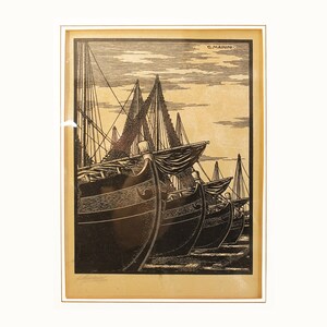 May include: A black and white woodcut print of a row of ships at a dock. The print is titled "G. Mainini" and is signed in the lower right corner.