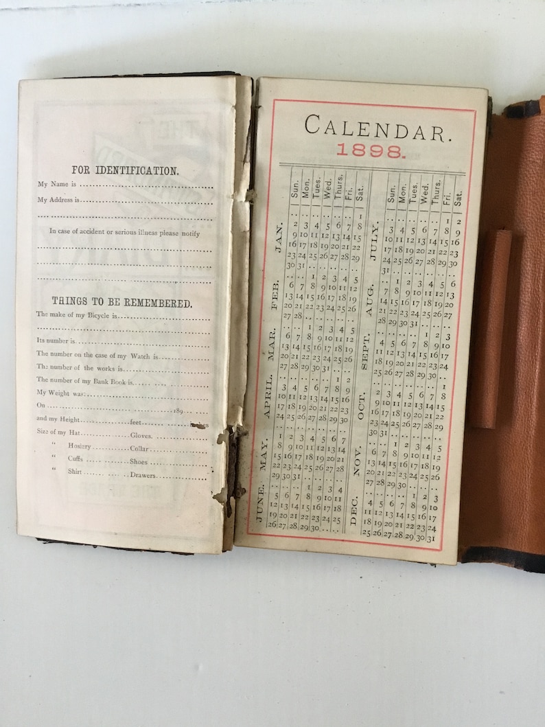 Two antique leather bound items; railroadsteamship wallet and a 1898 calendar diary.