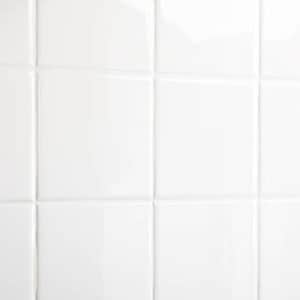 May include: A white tiled wall with a smooth, glossy finish. The tiles are arranged in a grid pattern.