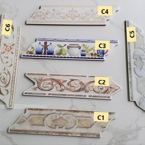 以下が含まれることがあります： さまざまな花柄と装飾的なデザインが施された、6種類のタイルのトリムピース。トリムピースには、C1、C2、C3、C4、C5、C6のラベルが付けられています。