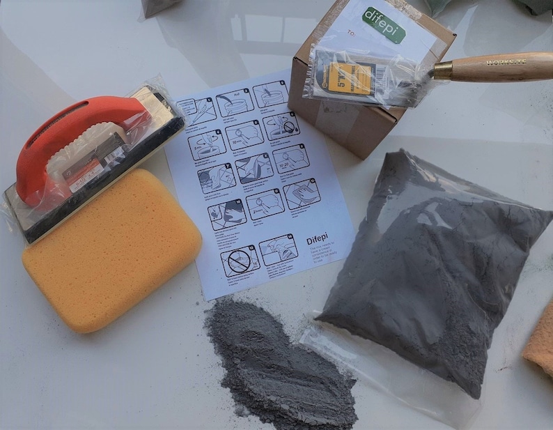 May include: A DIY kit for repairing cracks and holes in walls. The kit includes a bag of grey powder, a sponge, a trowel, a scraper, and instructions. The instructions show how to mix the powder with water and apply it to the wall.