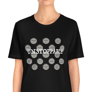May include: Black t-shirt with a graphic of a circle pattern with the word "UNSTOPPABLE" in white text.