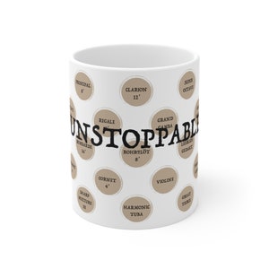 May include: White ceramic mug with a brown design featuring the word "UNSTOPPABLE" and various musical instrument names and sizes, including "Clarion 12'" and "Rohrflot 8'"