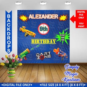 May include: A blue and yellow birthday party backdrop with the text "Alexander 9th Birthday" and "Dart Zone". The backdrop features a camouflage pattern and images of toy guns.