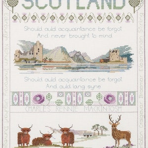 May include: A cross-stitch sampler with the word "SCOTLAND" in green and purple, flanked by thistles. It depicts a poem, a landscape, and images of Highland cattle and a deer. Scottish place names are listed along the borders of the sampler.