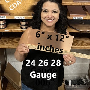 May include: A woman holds a 6 inch by 12 inch sheet of copper. The sheet is 24 gauge and .006 inches thick. The copper is CDA-110.