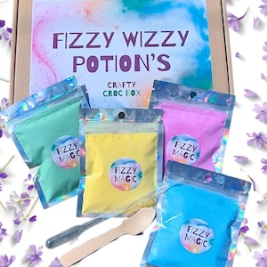 May include: Four small bags of colourful bath fizzies labelled "Fizzy Magic" in a cardboard box with the words "Fizzy Wizzy Potion's Crafty Croc Box".