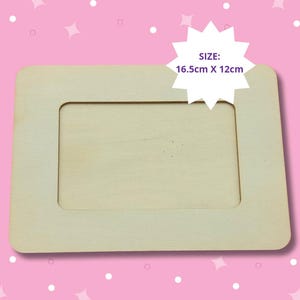 May include: A plain wooden picture frame with a 16.5 inch by 12 inch opening. The frame is made of unfinished wood and is ready to be painted or stained.