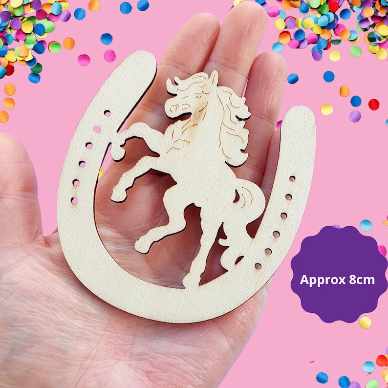 May include: Wooden horseshoe cutout with a horse design inside. The horseshoe is approximately 8 cm in diameter.