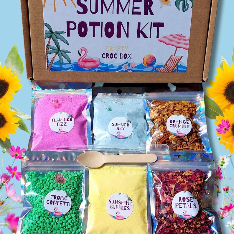 May include: A craft box labeled "SUMMER POTION KIT" with various ingredients in clear bags, including pink "Flamingo Fizz", blue "Summer Sky", and orange "Orange Crumble". A wooden spoon and other ingredients are also included.