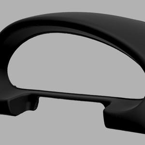 May include: Black plastic gauge pod for a car dashboard. The pod is designed to hold a single gauge and has a curved shape.