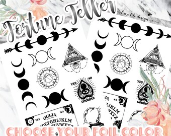 May include: Two sheets of black adhesive decals featuring occult-themed designs including moon phases, an all-seeing eye in a triangle, a planchette with the words YES, NO, and GOODBYE, and a Ouija board with the alphabet and the text OUIJA.