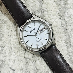 Reloj de pulsera automático Seiko LM vintage con esfera blanca, movimiento con fecha y día, n.º 5606-7070, fabricado en Japón, para hombre. Regalo para él