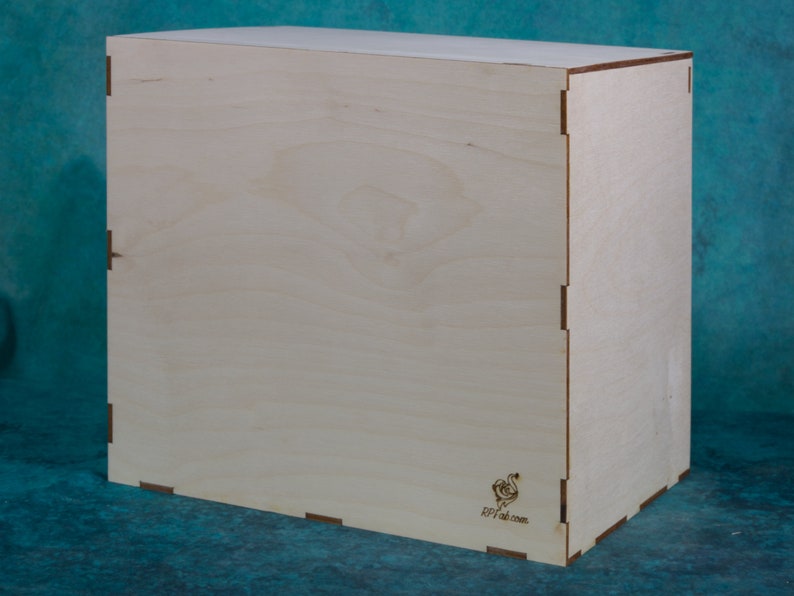 May include: A plain, light wood box with a small, laser-etched logo on the bottom right corner. The logo is a stylized bird with the text "RPI-craft.com".
