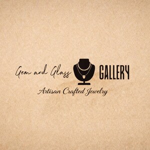 May include: Logo for Gem and Glass Gallery, featuring a black silhouette of a necklace on a bust, with the words "Gem and Glass GALLERY" and "Artisan Crafted Jewelry" in elegant script on a tan background.