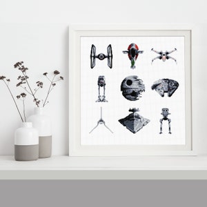 May include: A white framed print with a grid of nine black and white pixelated images of Star Wars spaceships and vehicles. The images include the Millennium Falcon, X-Wing, TIE Fighter, Death Star, and AT-AT.