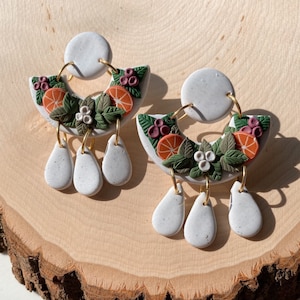 christmas clay earrings | holly earrings | cozy | holiday | orange slice | plant | statement | polymer clay | surgical steel posts | winter