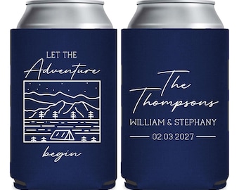 May include: Navy blue can cooler with white text and a camping-themed design. The front features the words "Let the Adventure begin" with a mountain and tent illustration. The back has "The Thompsons" and a date.