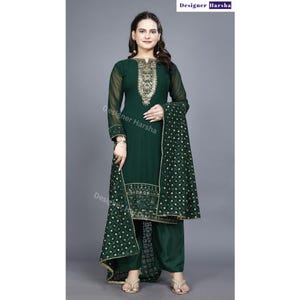 May include: A green salwar kameez with gold embroidery. The kameez has long sleeves and a round neckline. The salwar is a pair of loose-fitting pants. The dupatta is a long scarf that is often worn with a salwar kameez.