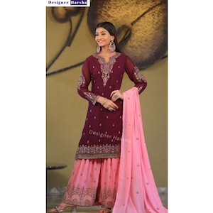 May include: A maroon and pink salwar kameez with embroidery. The kameez has long sleeves and a round neckline. The salwar is pink and has a printed design. The dupatta is pink and has a plain design. The text "Designer Harsha" is visible on the image.
