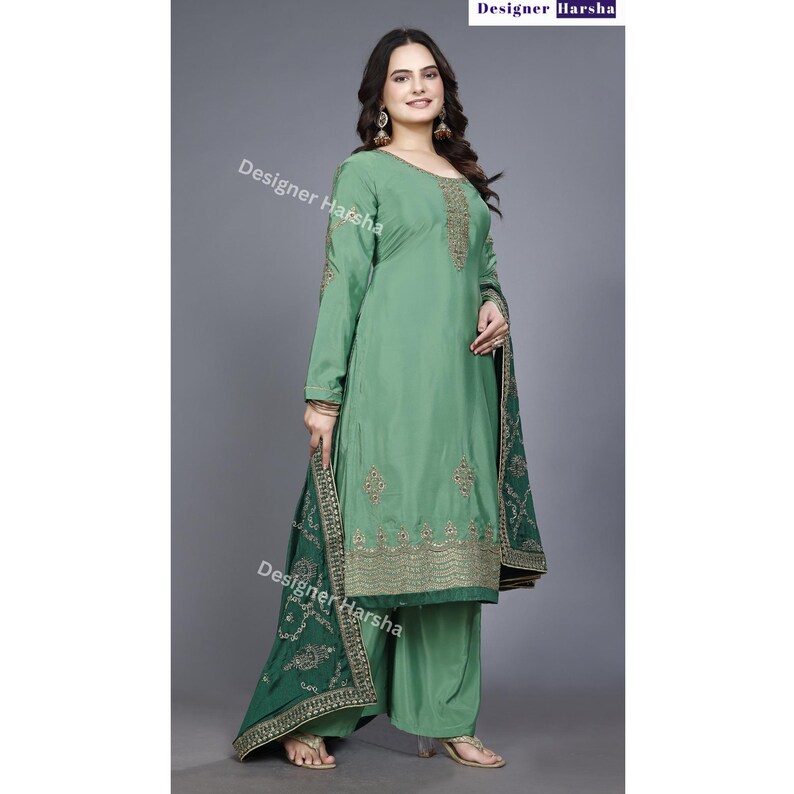 May include: A green salwar kameez with gold embroidery. The kameez has long sleeves and a round neckline. The salwar is a pair of wide-legged pants. The dupatta is a long scarf with a green and gold border.