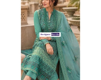 May include: A teal long-sleeved tunic with a mandarin collar and a dark green floral pattern, paired with matching trousers and a sheer embroidered dupatta. The garment features a central button placket and the text Designer Harsha.